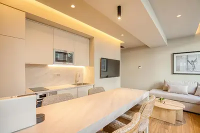 a kitchen and living room with a table and chairs at The Canopy Loft, A Curated 5-Star Experience in Athens