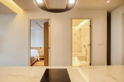 a bedroom with a bed and a door to a bathroom at The Canopy Loft, A Curated 5-Star Experience in Athens