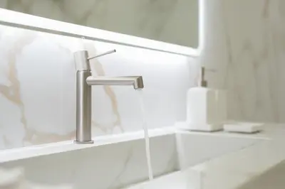 a bathroom sink with a hose coming out of a faucet at The Canopy Loft, A Curated 5-Star Experience in Athens
