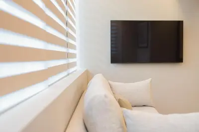 a living room with a couch and a tv at The Canopy Loft, A Curated 5-Star Experience in Athens