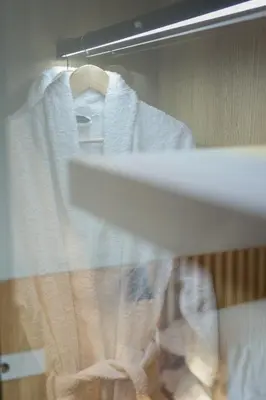 a towel hanging on a rack next to a sink at The Canopy Loft, A Curated 5-Star Experience in Athens