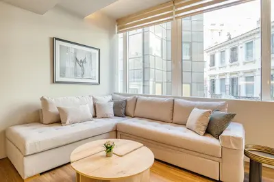 a living room with a couch and a table at The Canopy Loft, A Curated 5-Star Experience in Athens