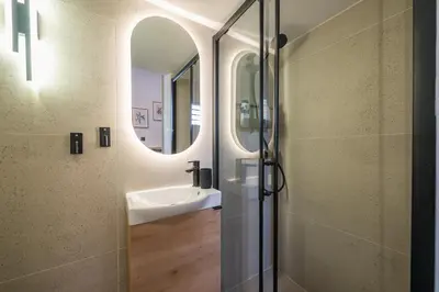 a bathroom with a sink and a mirror at Prime City Stay by Cloudkeys in Athens