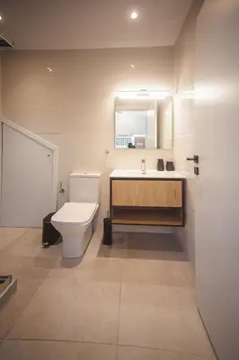 a bathroom with a toilet and a sink and a mirror at Zeno Apartments Athens in Athens