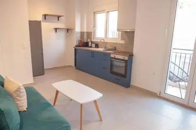 a kitchen with a couch and a table in a room at Zeno Apartments Athens in Athens