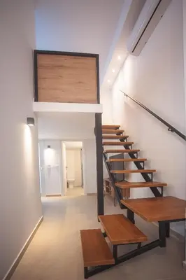 a staircase in a building with wooden benches at Zeno Apartments Athens in Athens