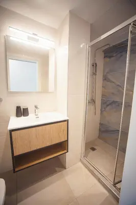 a bathroom with a sink and a shower at Zeno Apartments Athens in Athens