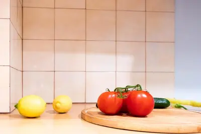 a table with tomatoes and other vegetables on a cutting board at DP Homes Acropolis Promenade in Athens