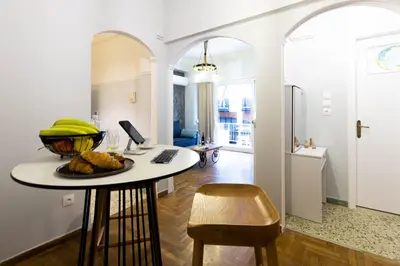 a kitchen with a table with a bowl of bananas on it at DP Homes Acropolis Promenade in Athens