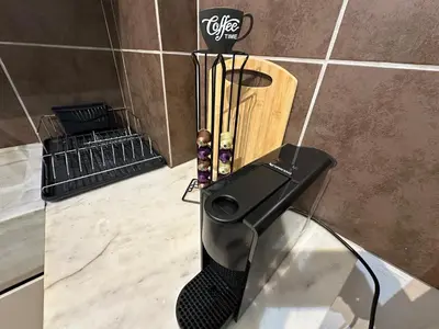 a glass table with a black brush on top of it at Upper Kypseli Nest Apartment in Athens