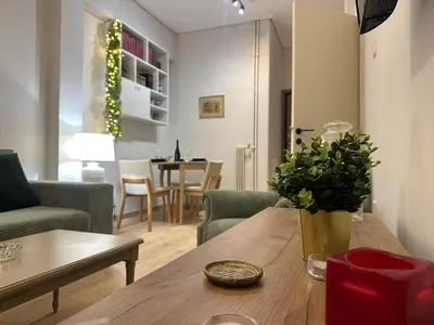 a living room with a table with a vase on it at Upper Kypseli Nest Apartment in Athens