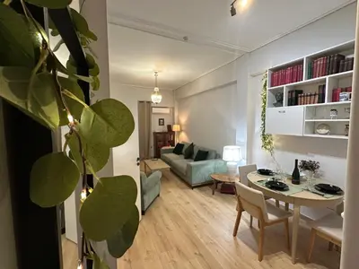 a living room with a table and a couch at Upper Kypseli Nest Apartment in Athens