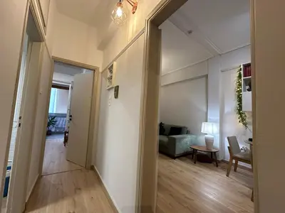 a hallway leading to a living room with a couch at Upper Kypseli Nest Apartment in Athens