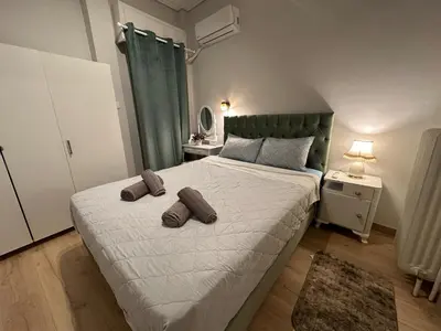 a bedroom with a bed with two pillows on it at Upper Kypseli Nest Apartment in Athens
