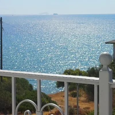 a view of the ocean from the balcony of a house at Kalimera Aegina in Agia Marina Aegina