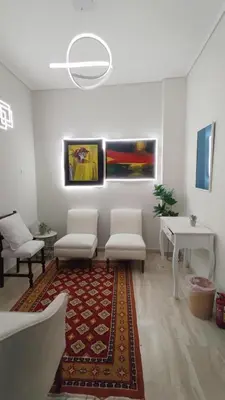 a living room with two chairs and a rug at Star Modern Apartment Kipseli in Athens