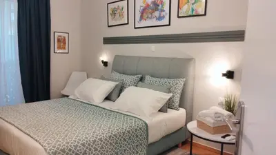 a bedroom with a large bed with white pillows at Star Modern Apartment Kipseli in Athens