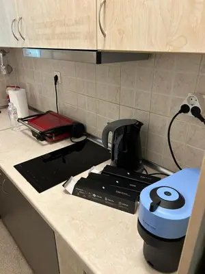 a kitchen counter with a coffee maker on a stove at Star Modern Apartment Kipseli in Athens