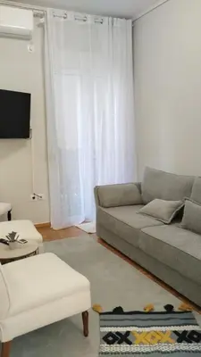 a living room with a couch and a table at Star Modern Apartment Kipseli in Athens