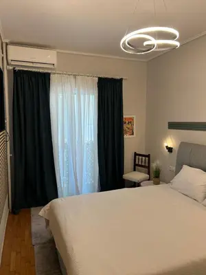 a bedroom with a large bed and a window at Star Modern Apartment Kipseli in Athens