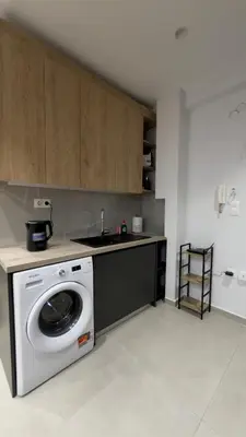 a kitchen with a washing machine and a sink at Modern 2BR Garden Apartment in Faliro Sleeps 5 in Athens