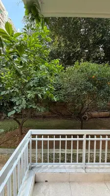 a white railing on a porch with trees in the background at Modern 2BR Garden Apartment in Faliro Sleeps 5 in Athens