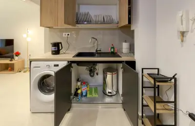 a kitchen with a sink and a washing machine at Modern 2BR Garden Apartment in Faliro Sleeps 5 in Athens