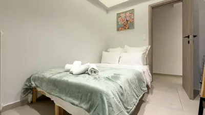 a bedroom with a bed with two stuffed animals on it at Modern 2BR Garden Apartment in Faliro Sleeps 5 in Athens
