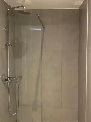 a shower with a glass door in a bathroom at Ermou 44 - 2bdr apartment in Athens