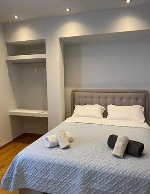 a bedroom with a bed with two towels on it at Ermou 44 - 2bdr apartment in Athens