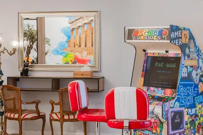 a room with two red chairs and a mirror at Artistic Luxury with Acropolis View in Psirri Monastiraki in Athens
