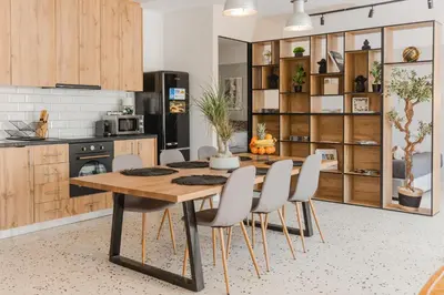 a kitchen with a wooden table and white chairs at Artistic Luxury with Acropolis View in Psirri Monastiraki in Athens