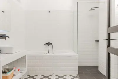 a white bathroom with a tub and a sink at Artistic Luxury with Acropolis View in Psirri Monastiraki in Athens