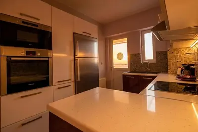 a kitchen with a refrigerator and a counter top at Elysian Sky Suite 421 in Athens