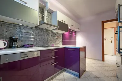 a kitchen with purple cabinets and purple counters at Elysian Sky Suite 421 in Athens