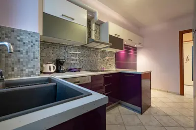 a kitchen with a sink and purple cabinets at Elysian Sky Suite 421 in Athens