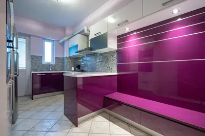 a purple kitchen with a bench in the middle at Elysian Sky Suite 421 in Athens