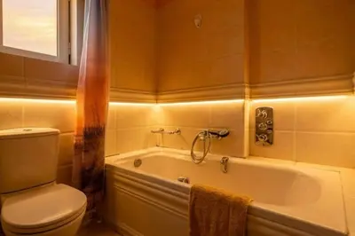 a bathroom with a white tub and a toilet at Elysian Sky Suite 421 in Athens