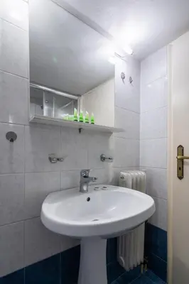 a bathroom with a white sink in a room at Beautiful apartment under Acropolis in Athens