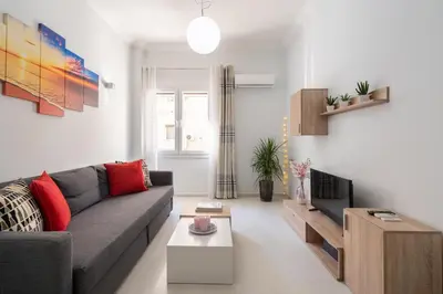 a living room with a couch and a tv at Beautiful apartment under Acropolis in Athens
