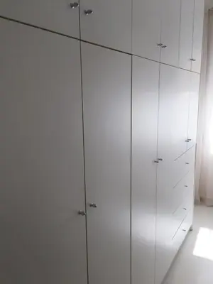 a white cabinet with four doors in a room at Beautiful apartment under Acropolis in Athens