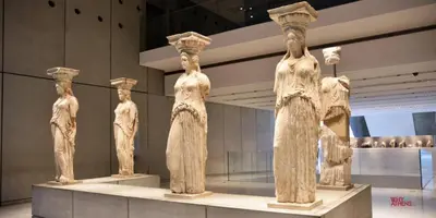 a group ofreek statues on display in a museum at Beautiful apartment under Acropolis in Athens