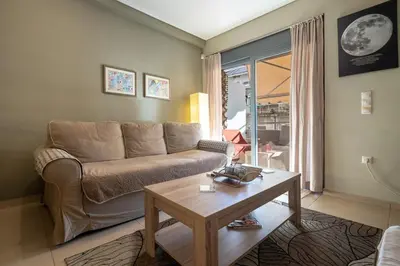 a living room with a couch and a table at Athens City Easy Move - Patissia by ΜΡS in Athens