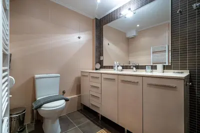 a bathroom with a toilet and a sink and a mirror at Athens City Easy Move - Patissia by ΜΡS in Athens