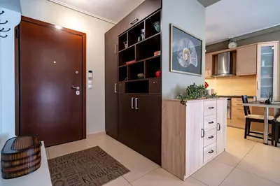 a kitchen with a wooden door and a dining room at Athens City Easy Move - Patissia by ΜΡS in Athens