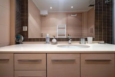a bathroom with a sink and a large mirror at Athens City Easy Move - Patissia by ΜΡS in Athens