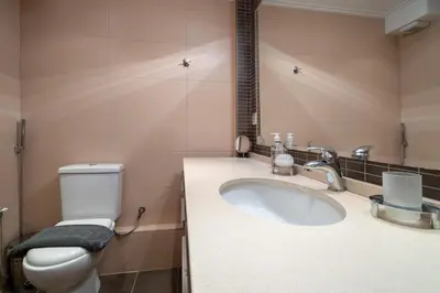 a bathroom with a white toilet and a sink at Athens City Easy Move - Patissia by ΜΡS in Athens