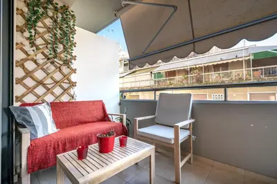 a red couch and a chair on a balcony at Athens City Easy Move - Patissia by ΜΡS in Athens