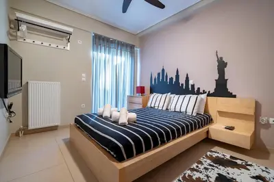 a bedroom with a bed with a blue and white striped sheets at Athens City Easy Move - Patissia by ΜΡS in Athens