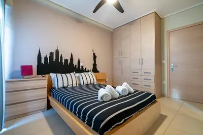 a bedroom with a bed with white towels on it at Athens City Easy Move - Patissia by ΜΡS in Athens